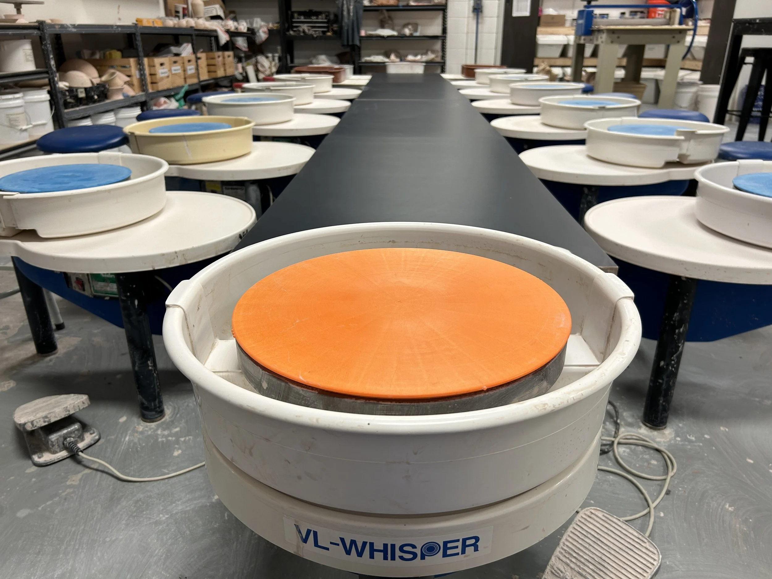 Two lines of clean wheels ready for students to learn. At Old School Farm Pottery, a nonprofit in Nashville