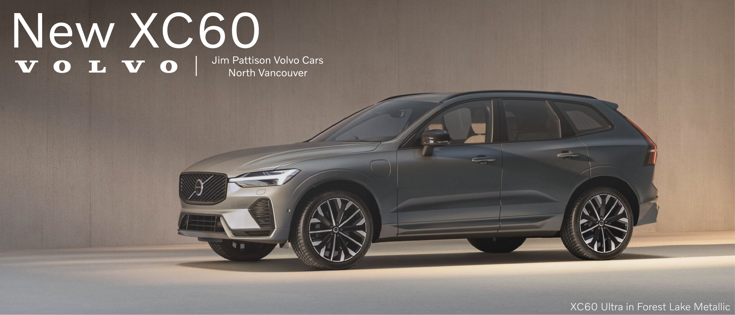 Image of a new silver XC60 Volvo SUV on a beige background with text advertising Jim Pattison Volvo Cars North Vancouver. The car has black and silver alloy wheels, a modern front grille, and sleek lighting design.