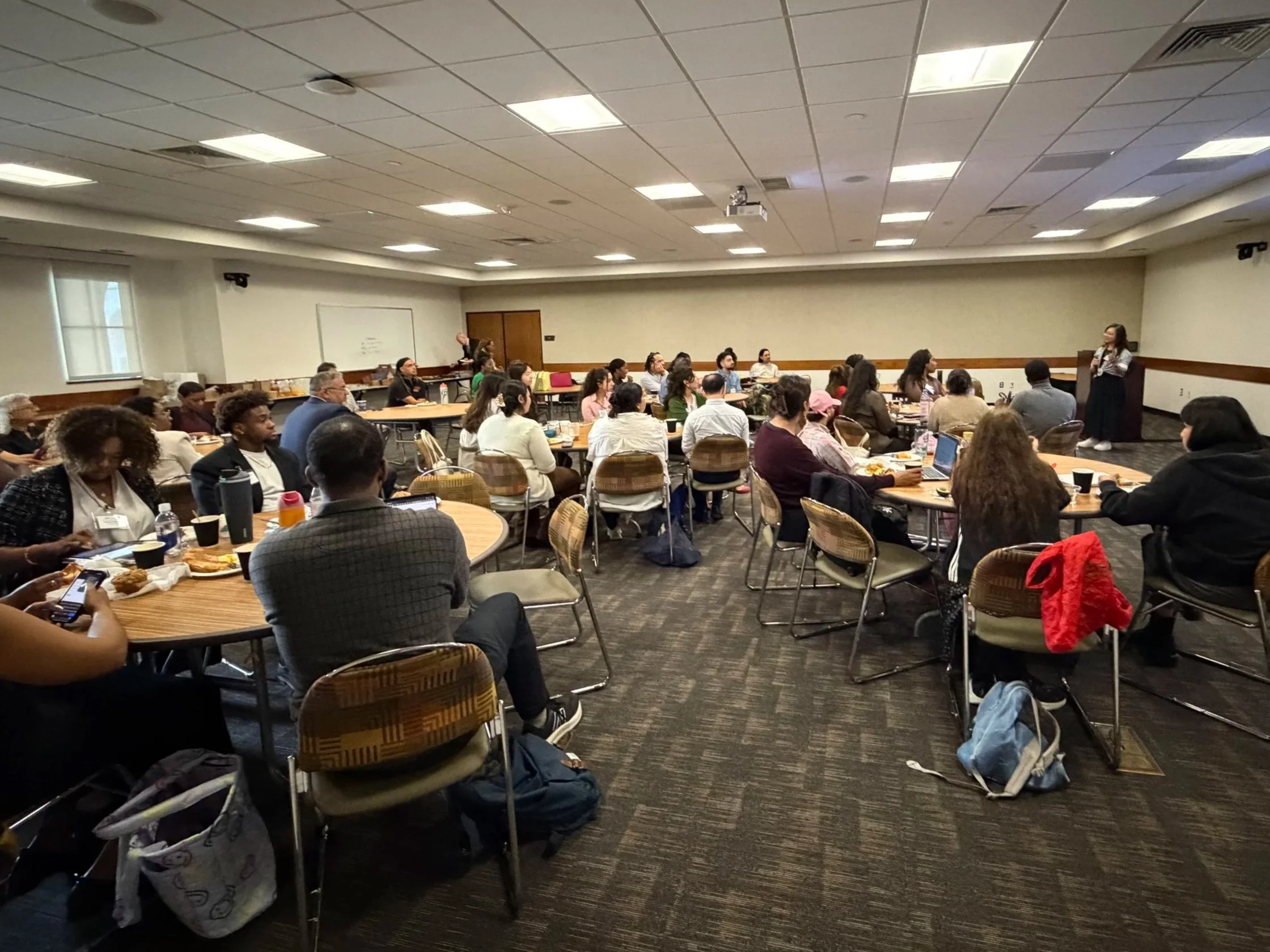 Dr. Nellie Tran speaking to large group of students