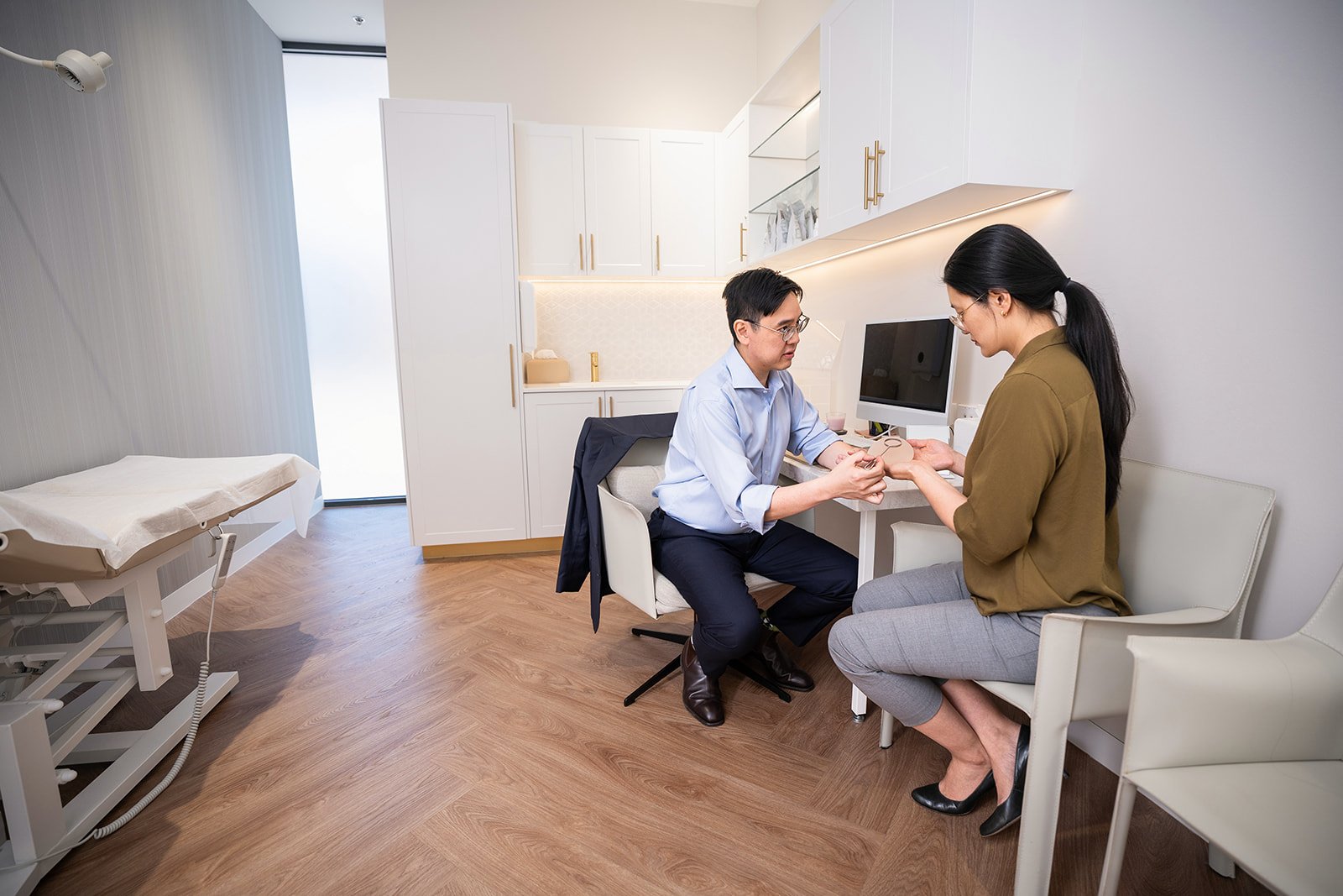 Cosmetic surgeon patient consultation hands Melbourne professional photography