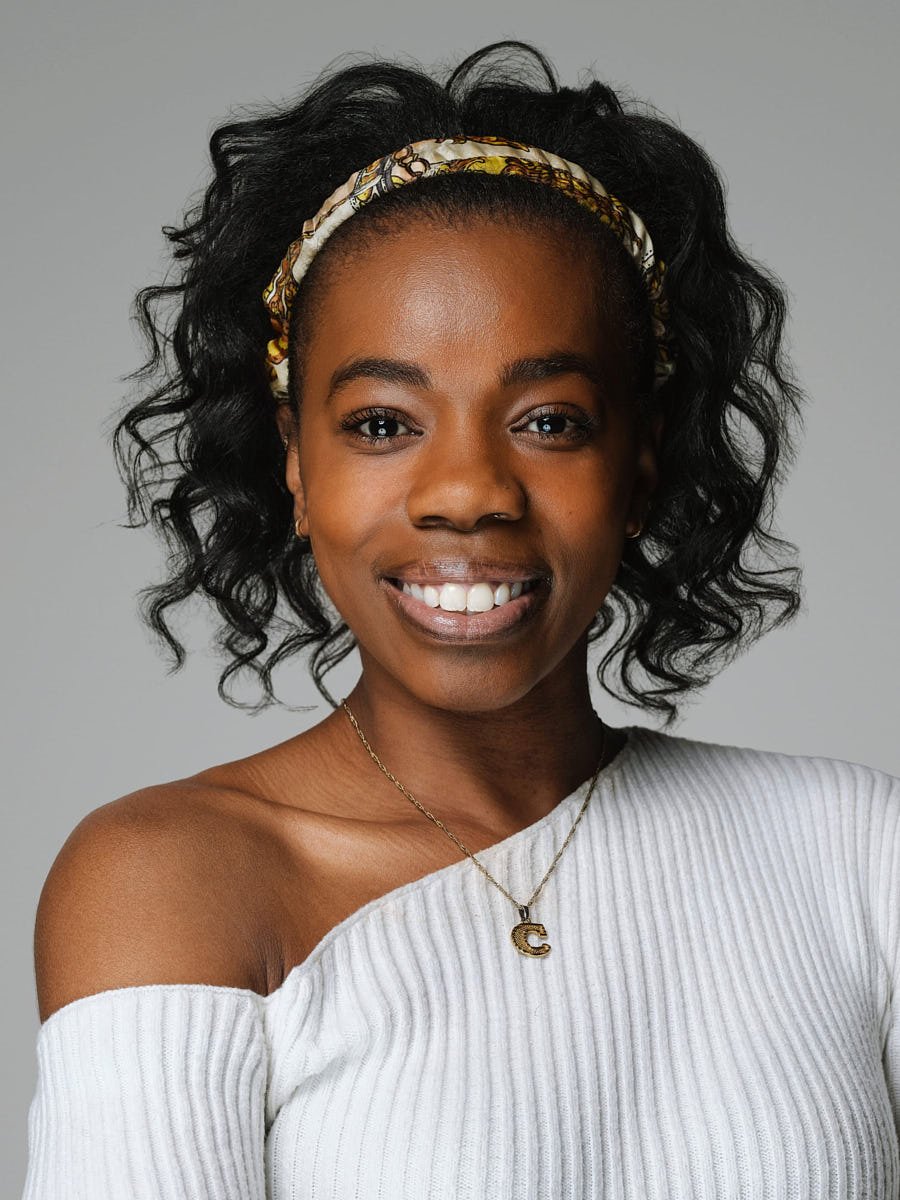 headshots-nyc-woman-white-sweater-gray-background.jpg