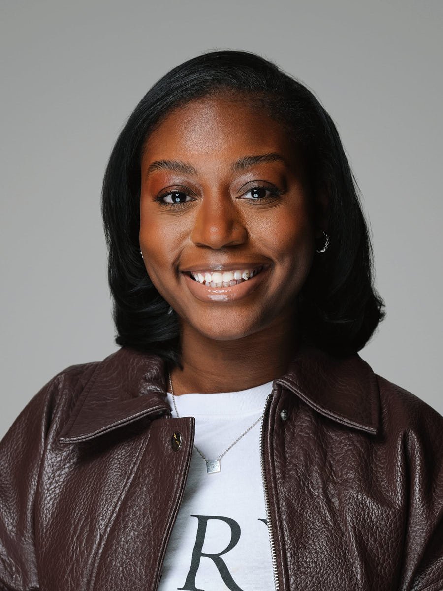 corporate-headshot-nyc-woman-leather-jacket-gray-background.jpg