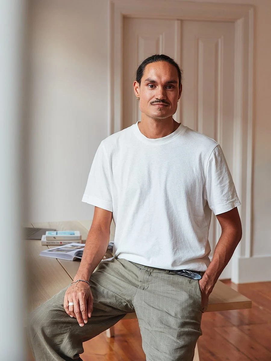 personal-branding-photography-nyc-man-white-tshirt-seated-in-hallway.jpg