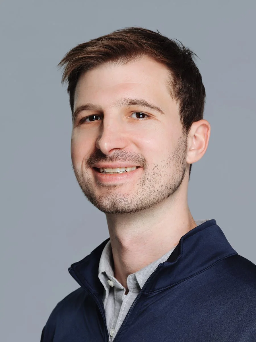 headshots-nyc-man-navy-jacket-gray-background.jpg