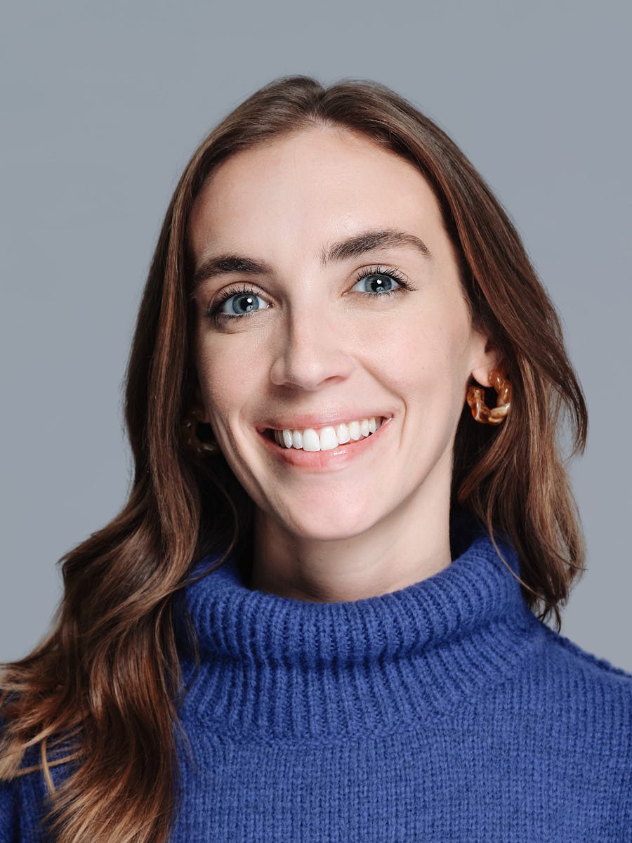 corporate-headshot-nyc-woman-blue-sweater-gray-background.jpg