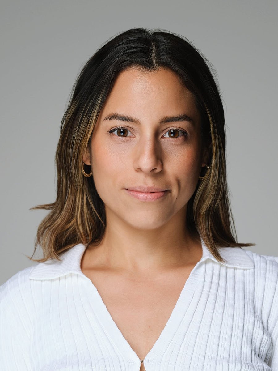 executive-portrait-nyc-woman-white-sweater-gray-background.jpg