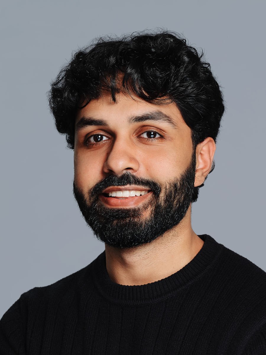 corporate-headshot-nyc-man-black-sweater-gray-background.jpg