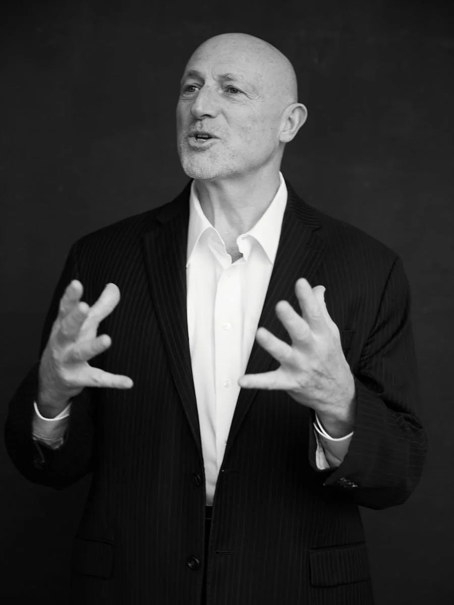 personal-branding-photography-nyc-black-and-white-man-dark-suit-gesturing.jpg
