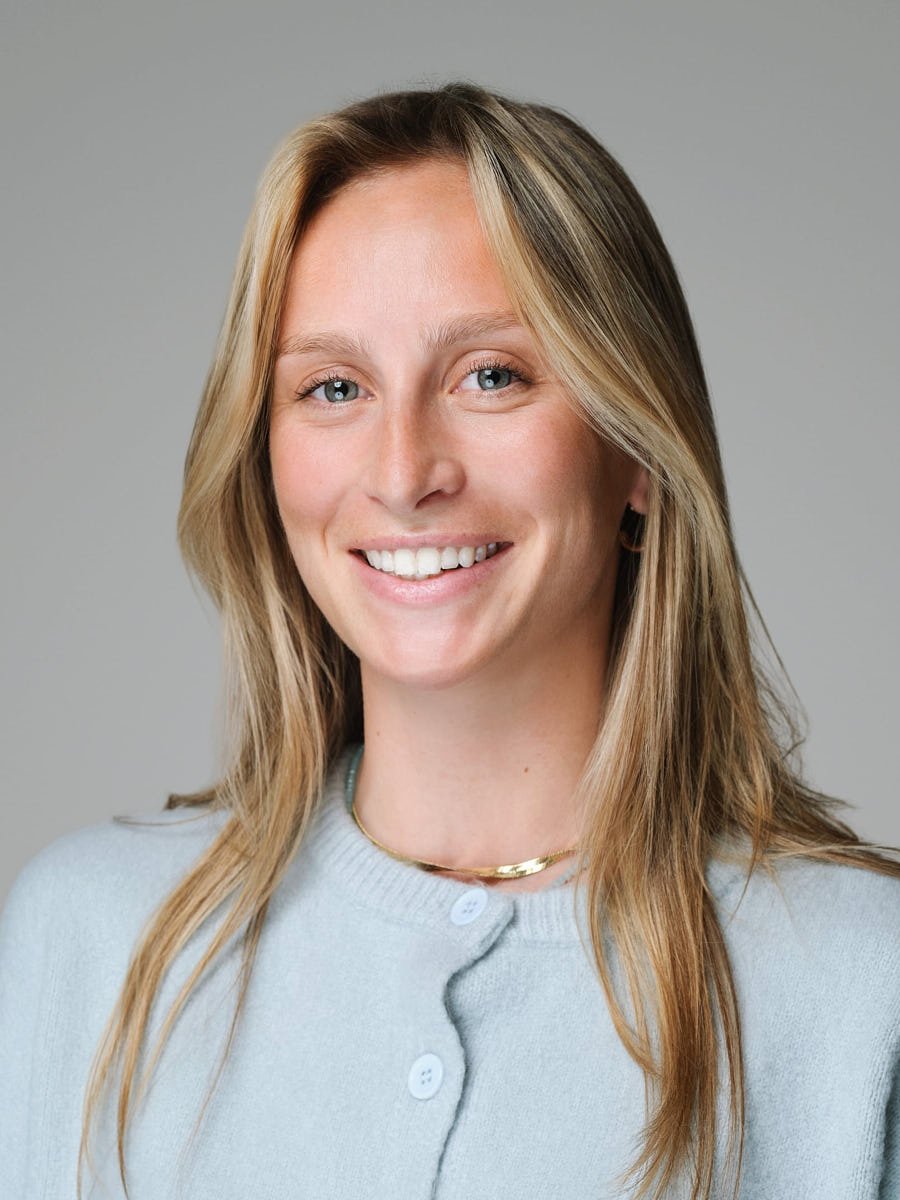 headshots-nyc-woman-light-blue-cardigan-gray-background.jpg