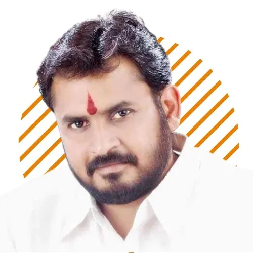 A man with a red mark on his forehead, wearing a white shirt, against a background with orange diagonal stripes.