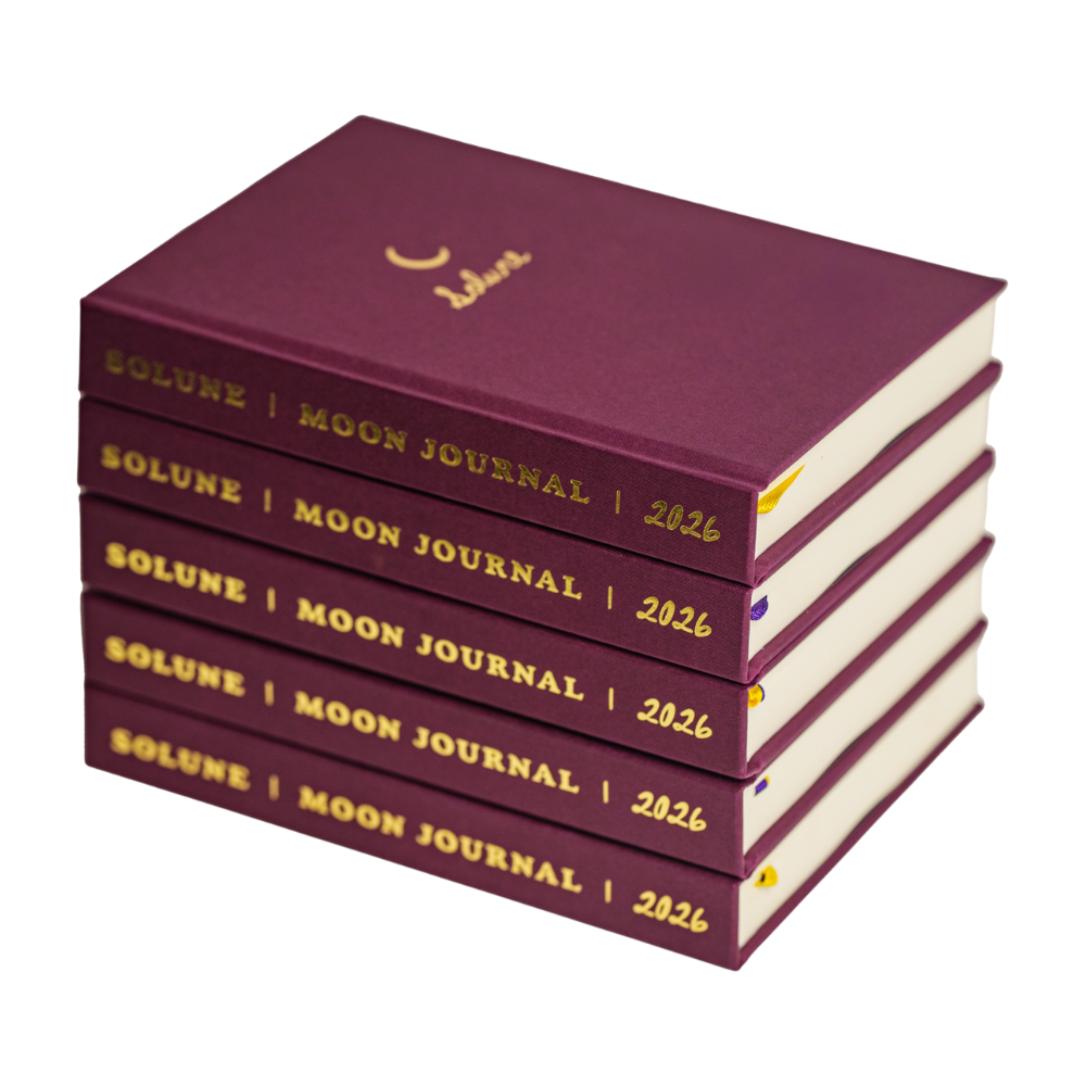 Four purple moon journal planners stacked on top of each other, each labeled Solune | Moon Journal | 2026 in gold text.