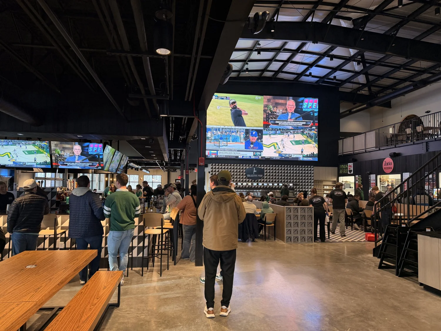 Westfield Collective main hall with the 25 ft LED video wall and a crowd watching games