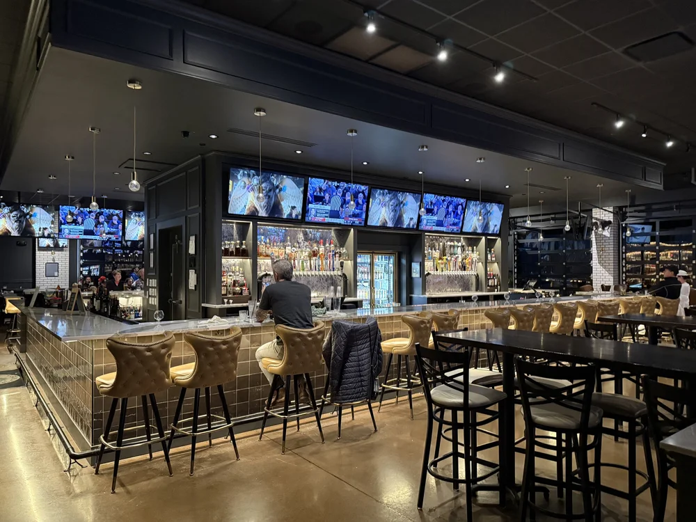 Restaurant bar with ceiling speakers and wall-mounted displays