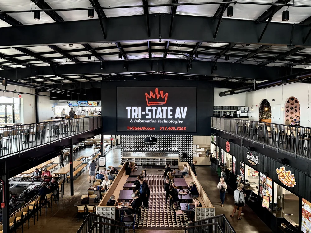 25 ft by 14 ft LED video wall with the Tri-State AV logo above the Westfield Collective dining hall