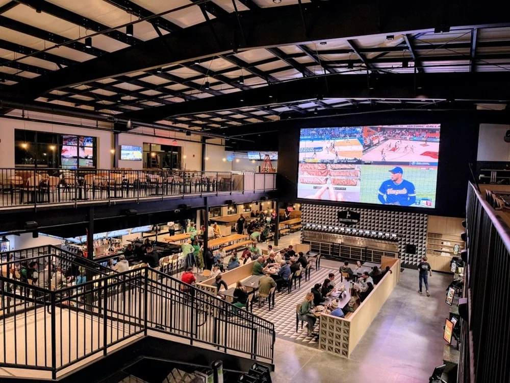 Sports bar with a large LED wall and multiple synchronized TVs