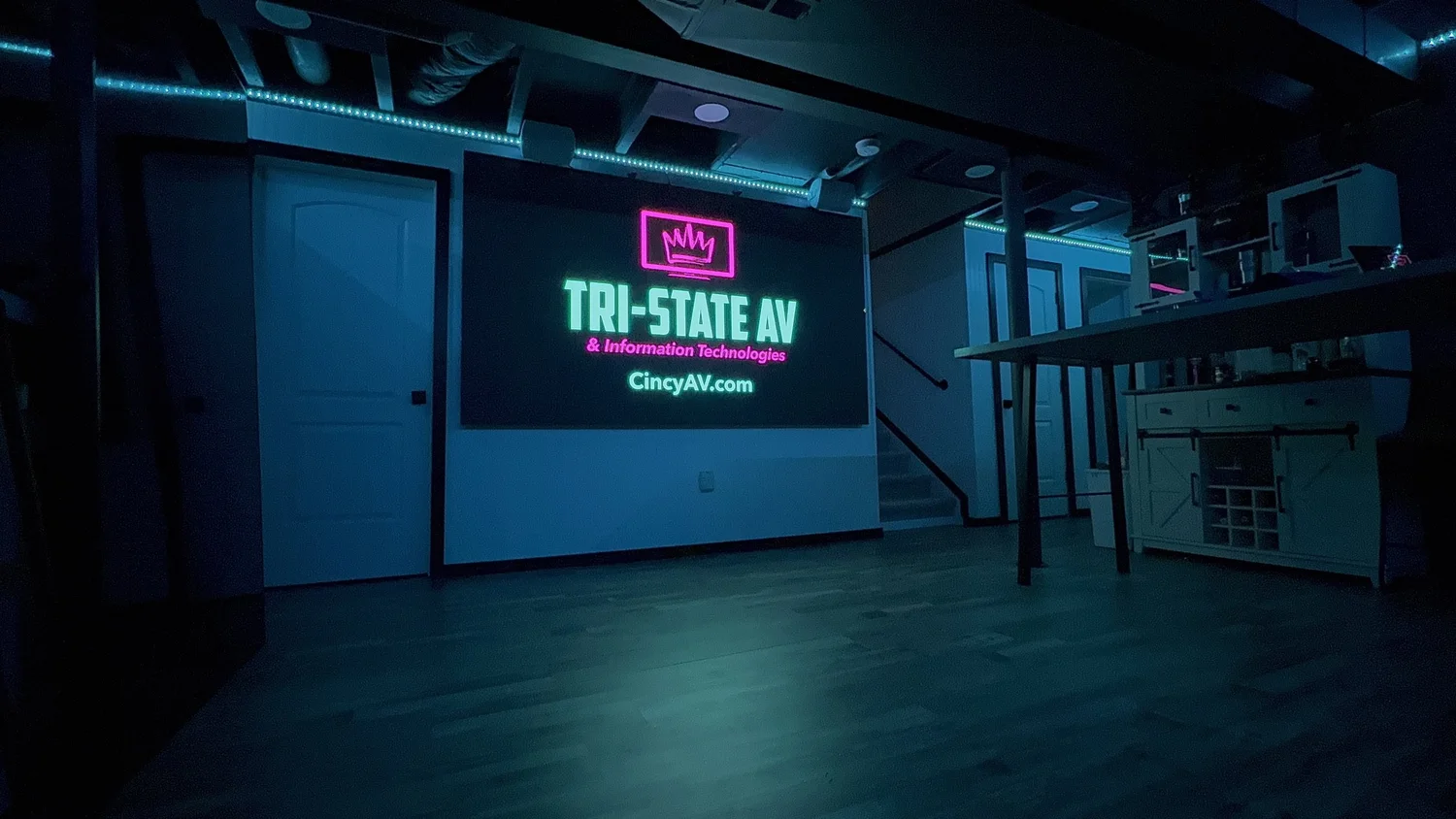 LED video wall glowing with the Tri-State AV logo in a dark commercial space