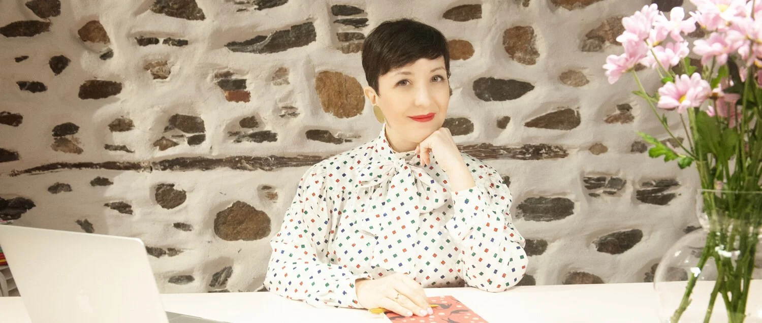 Chiara Aliotta sitting at her desk with her computer and some workshop tools