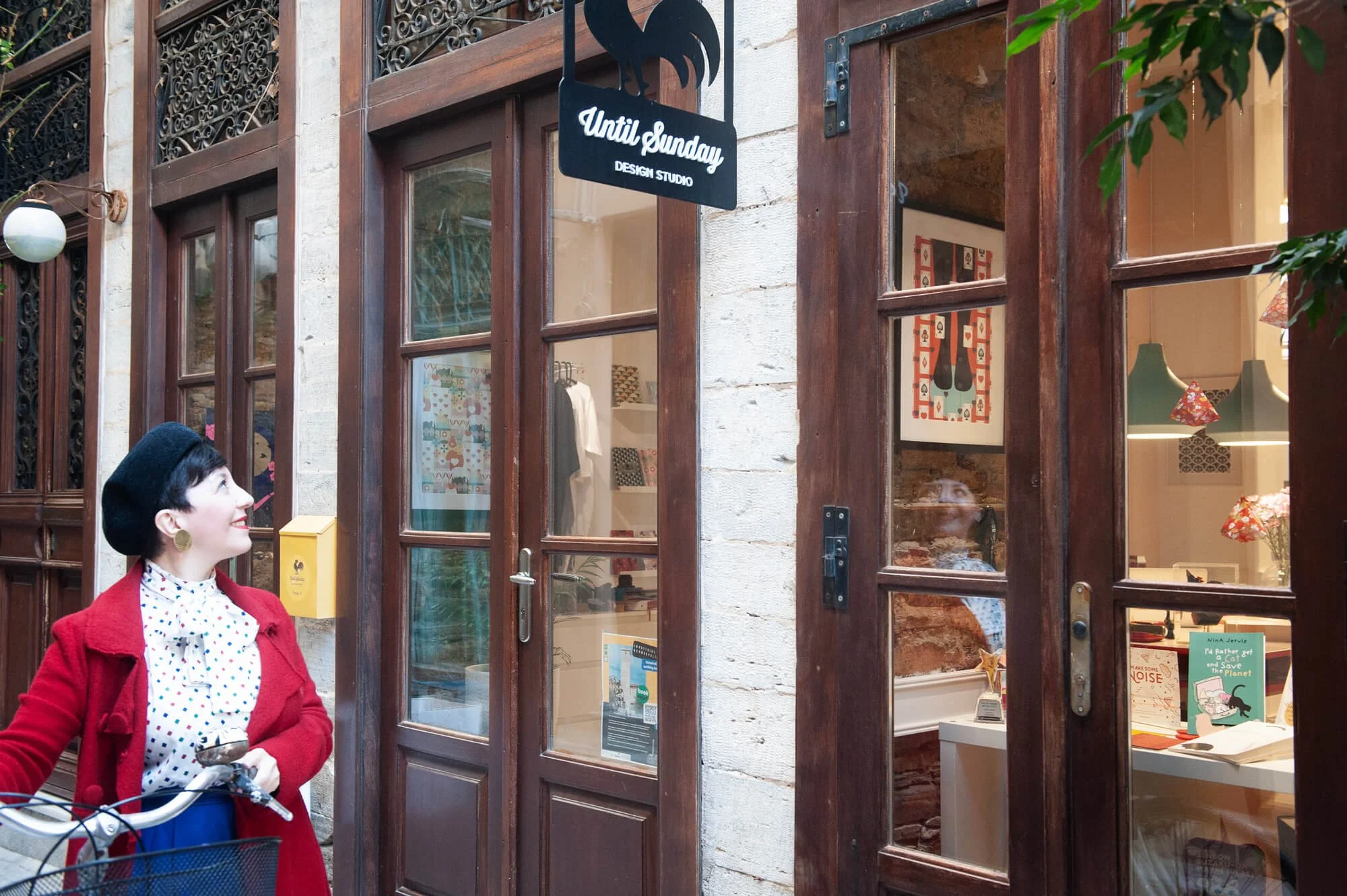 Chiara Aliotta walking outside her office holding a bicycle.