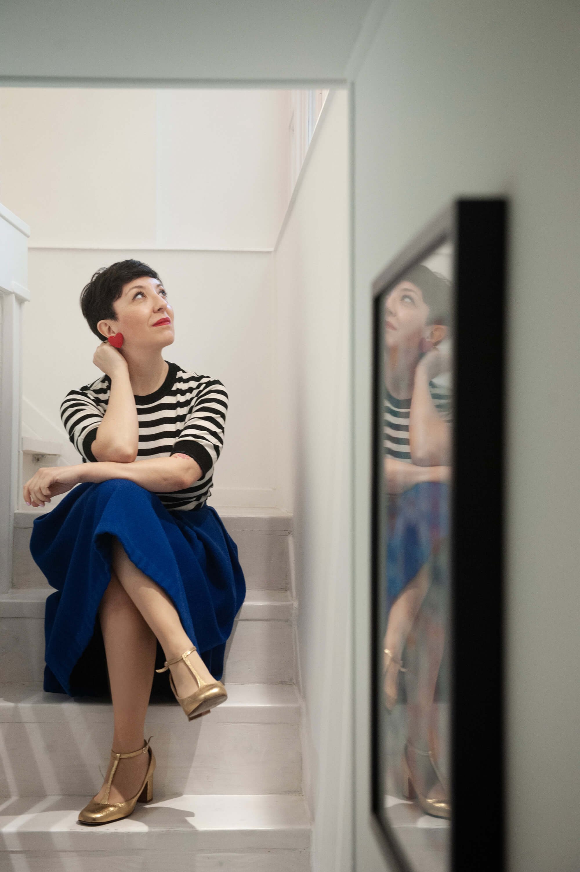 Chiara Aliotta sitting on the staircases of her studio.