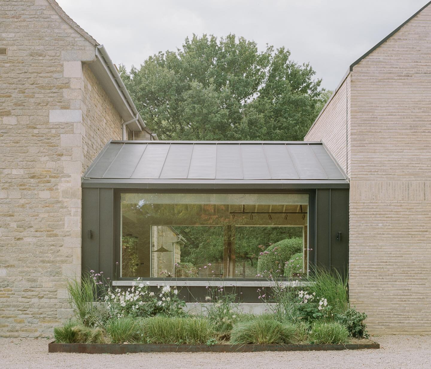 The link between the old stone house and the new brick extension is clad in metal and houses the main kitchen space. 

Our approach was to design a series of gabled additions that related closely to the original house in terms of form, scale, proport