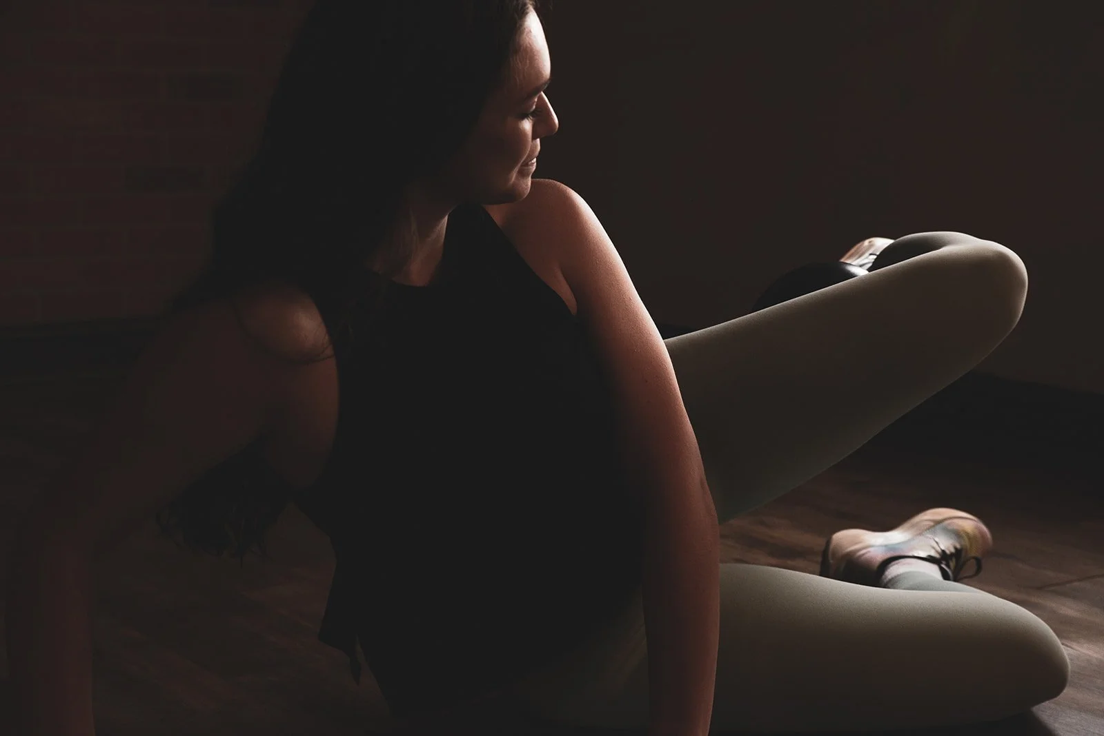 arms reaching overhead with light hand weights in a barre exercise