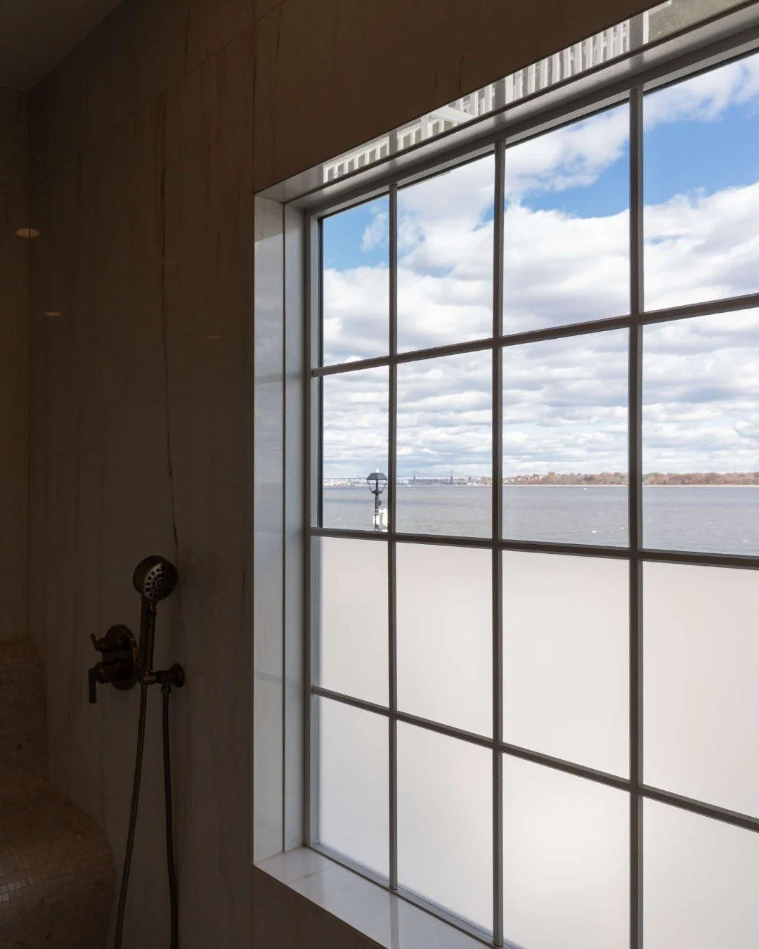 Large windows in the shower are a dream for natural light and views&mdash;until privacy becomes a concern.

We love solving this with a simple, elegant approach: frost the lower half of the window and let the window&rsquo;s lines guide the design. Yo