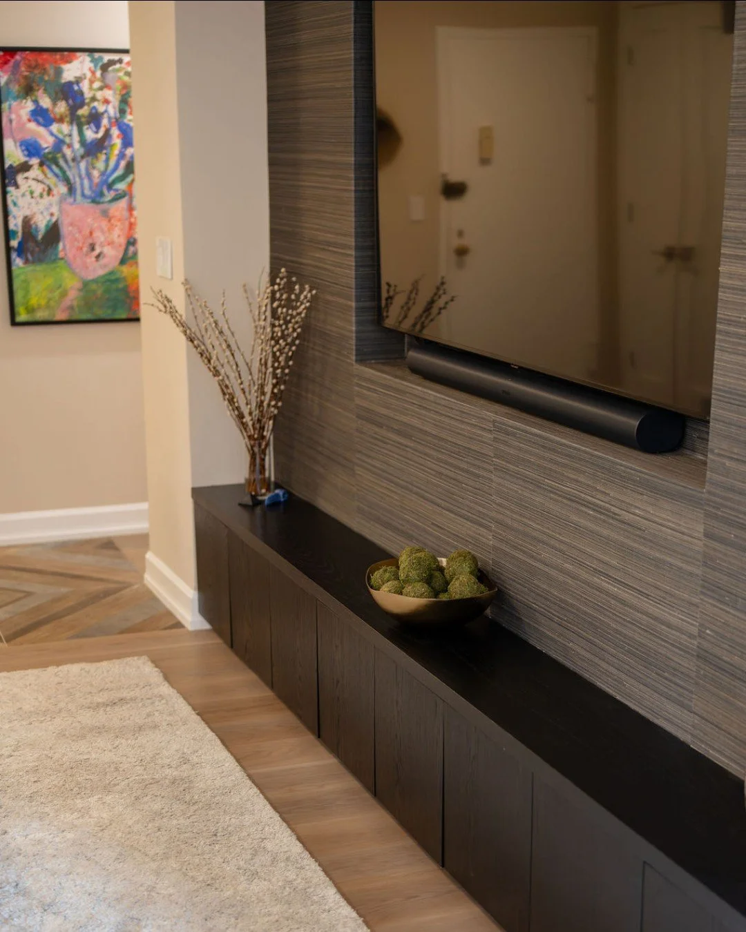 We&rsquo;re loving how this custom media cabinet turned out 🤩 The long, linear profile pairs perfectly with the grasscloth wallpaper, and the darker color palette helps the TV feel integrated&mdash;finally, a media wall that looks intentional, not l