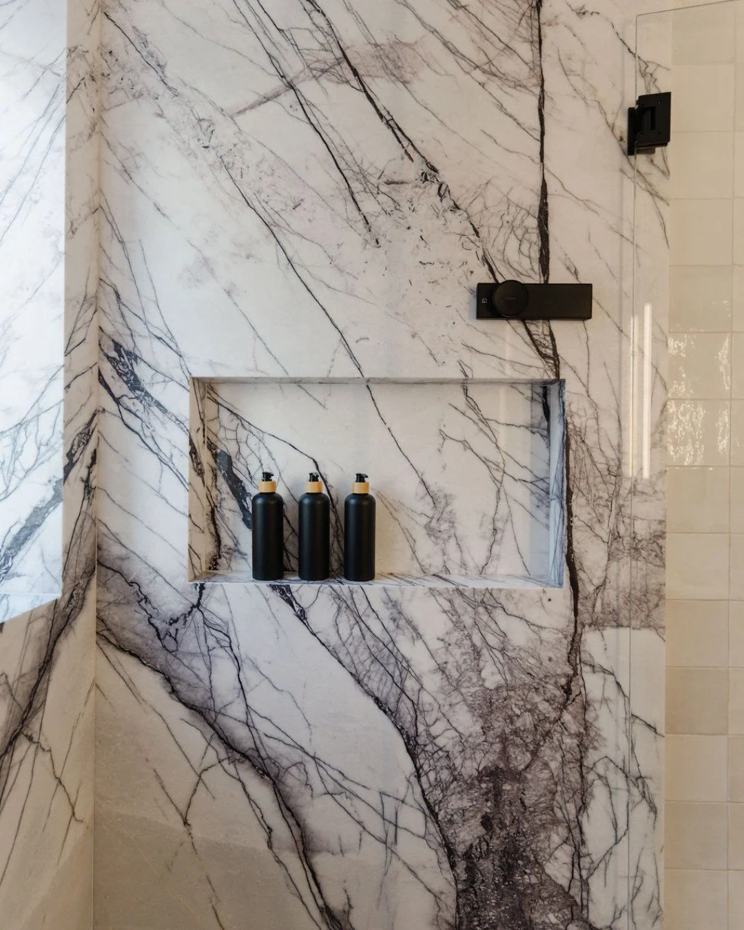 This shower was our starting point&mdash;and honestly, it set the tone for the entire room. 

We took the time to slab-match the Lilac Marble on every wall, carrying the veining right into the window frame and the shower niche for a truly seamless lo