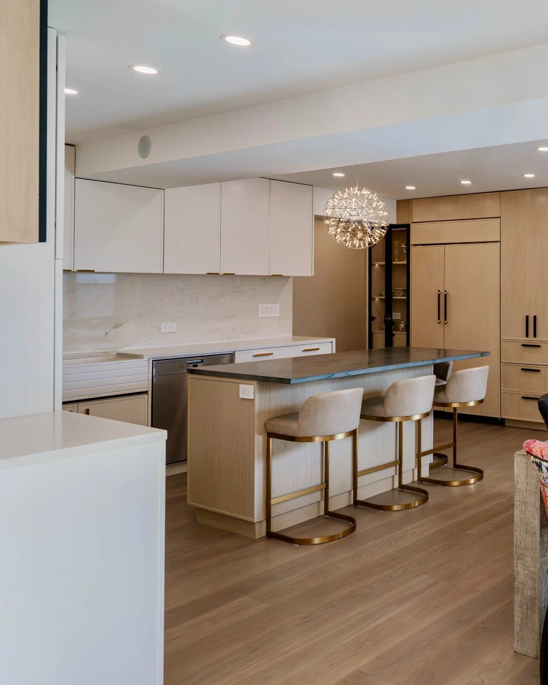 A calm foundation with moments of surprise ✨

This kitchen leans into a quietly playful balance&mdash;layering warm neutrals with bold printed seating and sculptural lighting that feels more art than fixture. Subtle in palette, expressive in detail, 