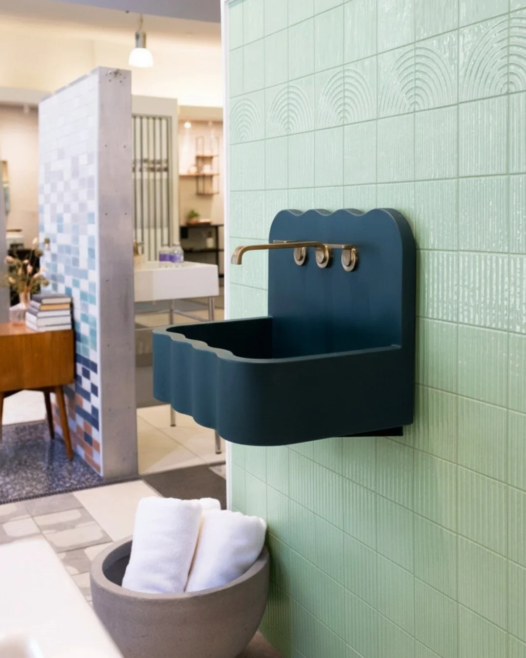 We&rsquo;re loving how the Kast concrete Tilde wall-mounted sink anchors the green-toned vignette in our Nemo Tile + Stone collaboration💚 Its matte, sculptural form adds depth while keeping the palette calm and balanced&mdash;letting texture and pat