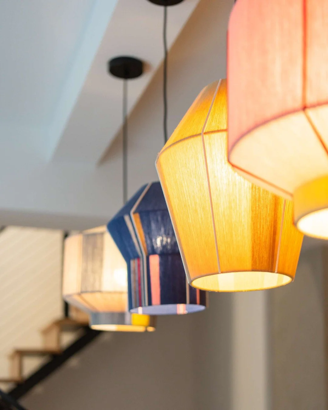 In this dining space, we set out to create true visual impact&mdash;leaning into our client&rsquo;s love of color, texture, and organic form. The Bonbon Shades, inspired by line drawings, are hand-wrapped in colored yarn over a sculptural steel frame