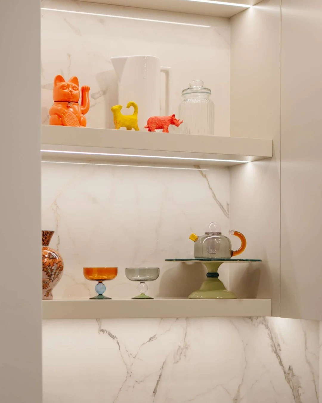 We often use open shelving in kitchen design as a thoughtful counterbalance to closed upper cabinetry.

While full runs of cabinetry create a clean, uninterrupted look, introducing moments of open shelving helps break up visual weight and brings vari
