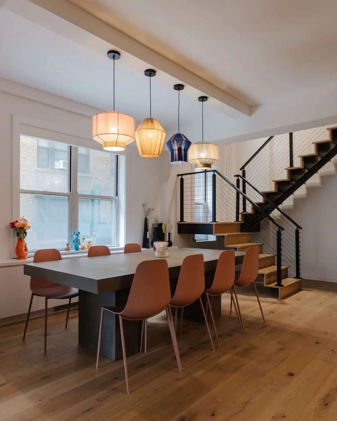 The dining area becomes the true focal point of the entire first floor&mdash;anchoring the home with both presence and personality!

An oversized concrete table introduces an industrial foundation through its material and scale, grounding the space w