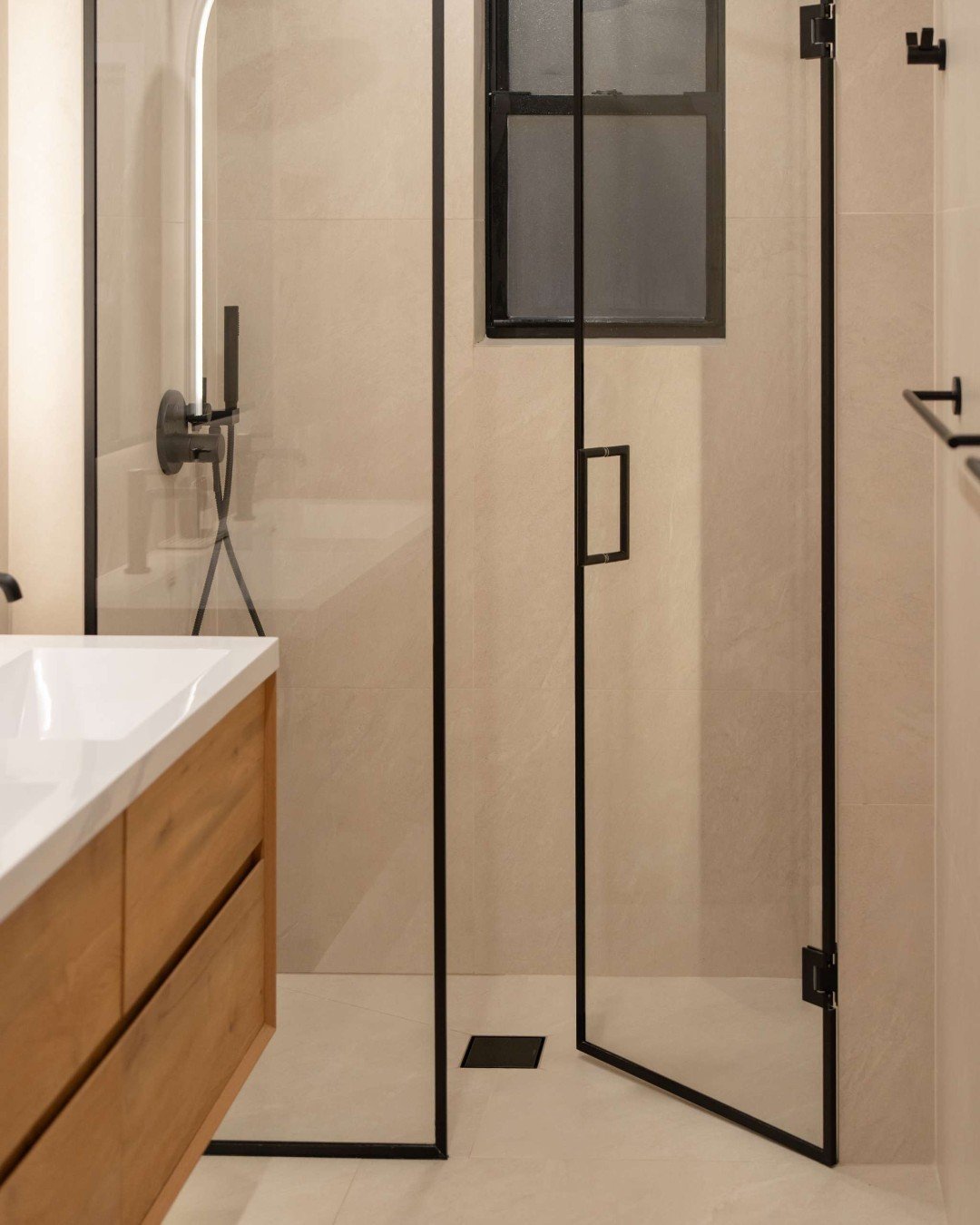 This bathroom is all about seamless design and quiet impact.

Wrapped in large-format tile across all four walls and the shower, the space feels continuous, calm, and intentionally minimal &mdash; allowing the materials to do all the talking. The sca