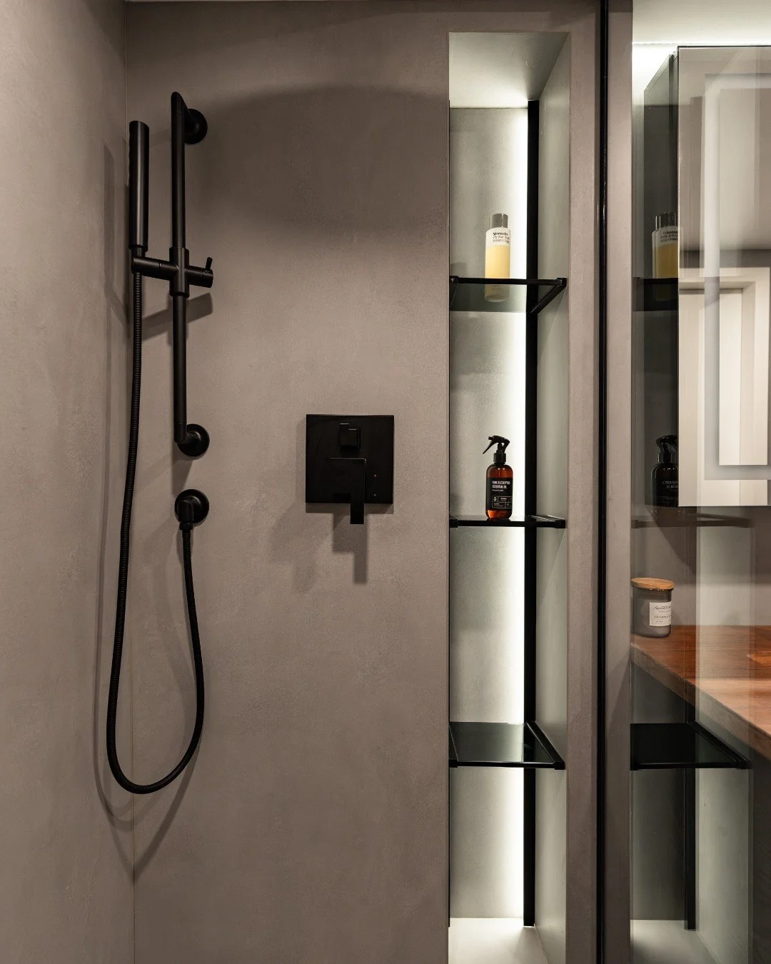 Designed to feel immersive, calming, and completely uninterrupted.

Large-format Alta Grey porcelain tiles wrap every surface of this primary bathroom&mdash;from the walls to the shower to the flooring&mdash;creating a seamless, womb-like environment