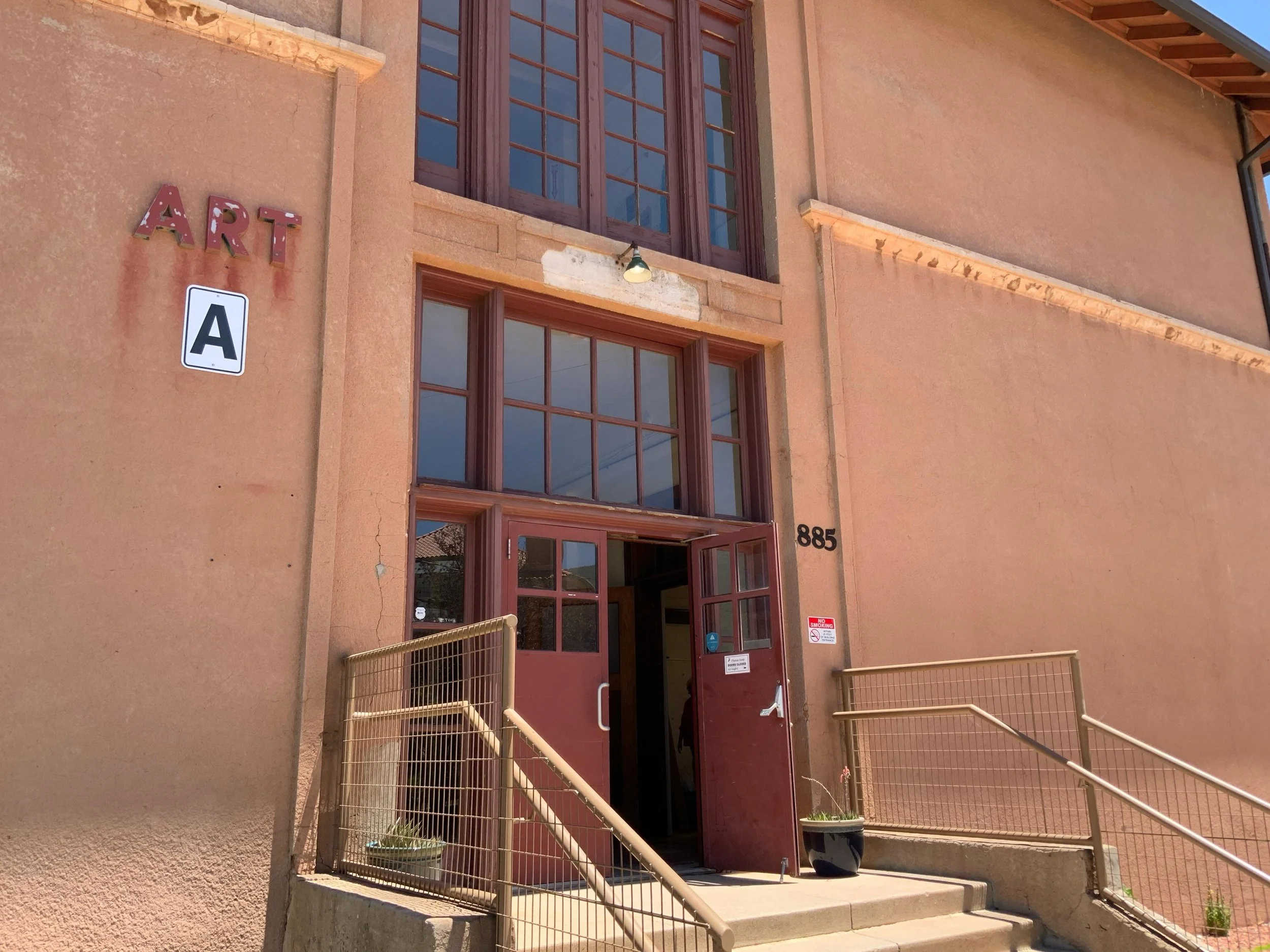 a terracotta colored building with a big A for Art