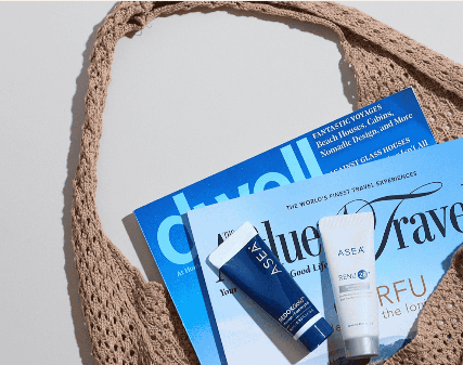 Styled flat lay of wellness products and magazines arranged in a woven tote bag for brand photoshoot art direction