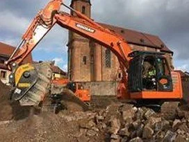 An excavator digging in a construction site.