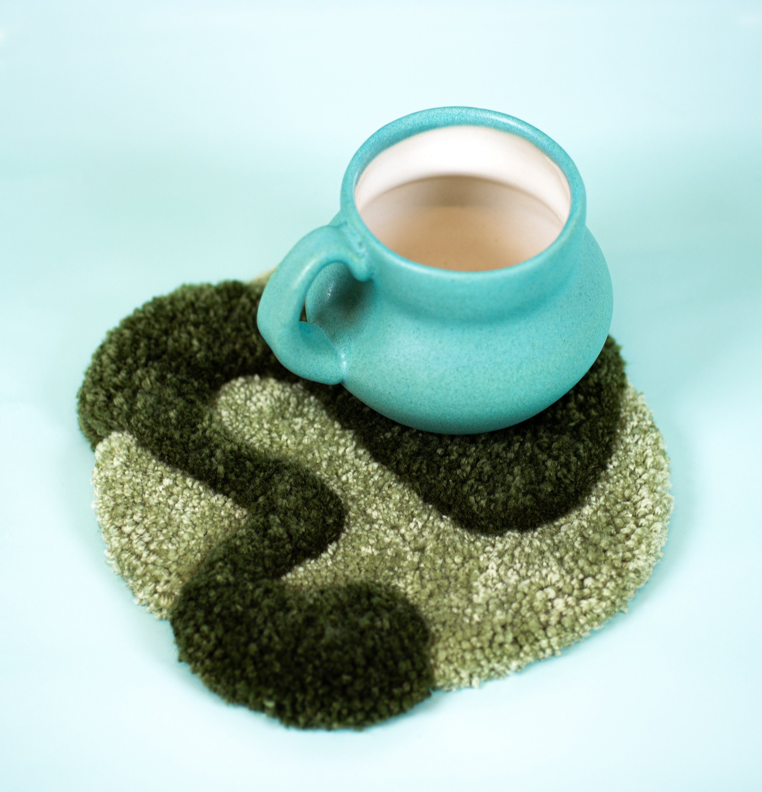 Mug Rug II |
2023 |
Porcelain, Glaze, Yarn, Textiles