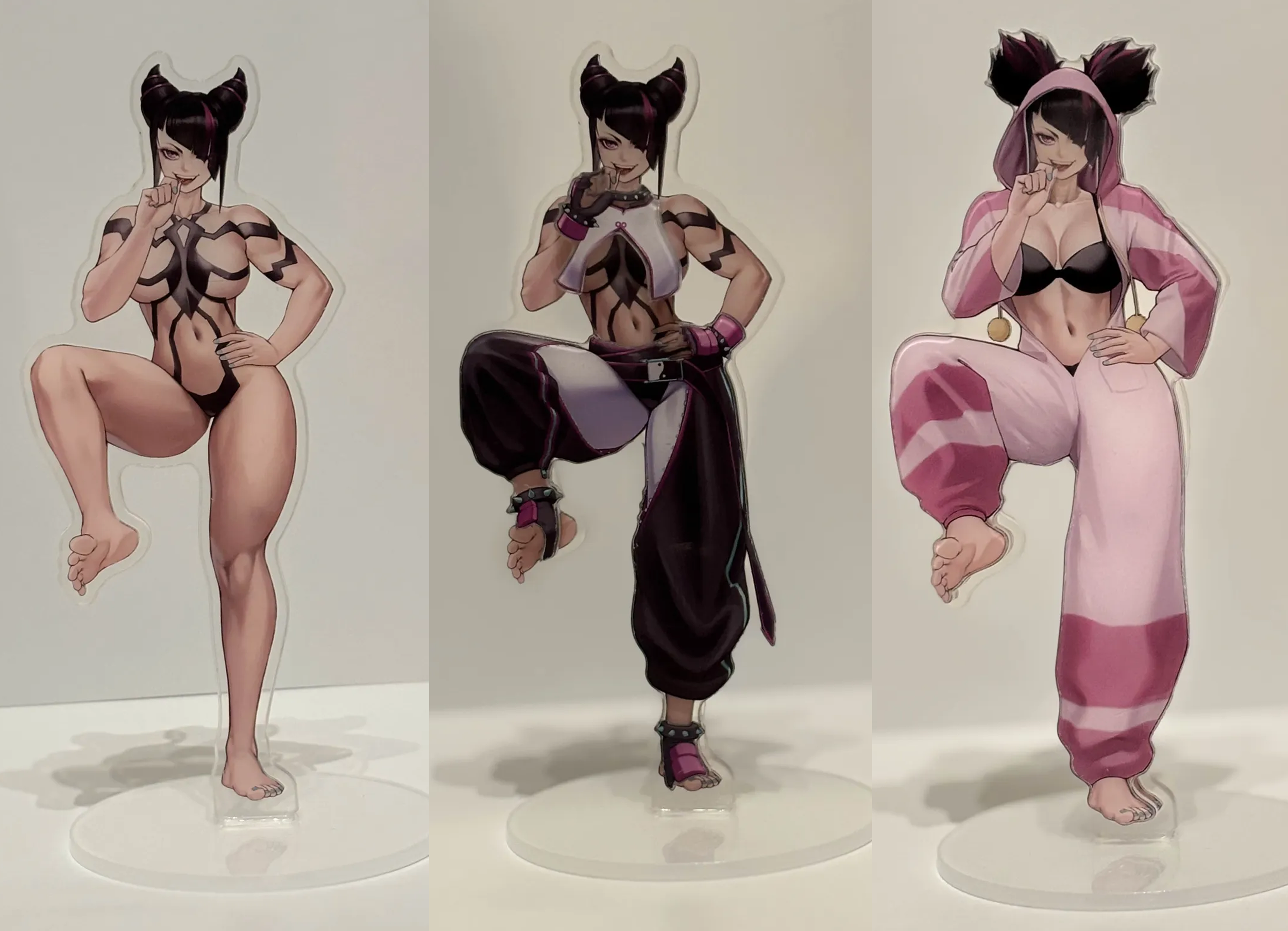 Three anime-style stickers of a female character with black hair and feline ears, each in different outfits and poses, standing on clear bases.