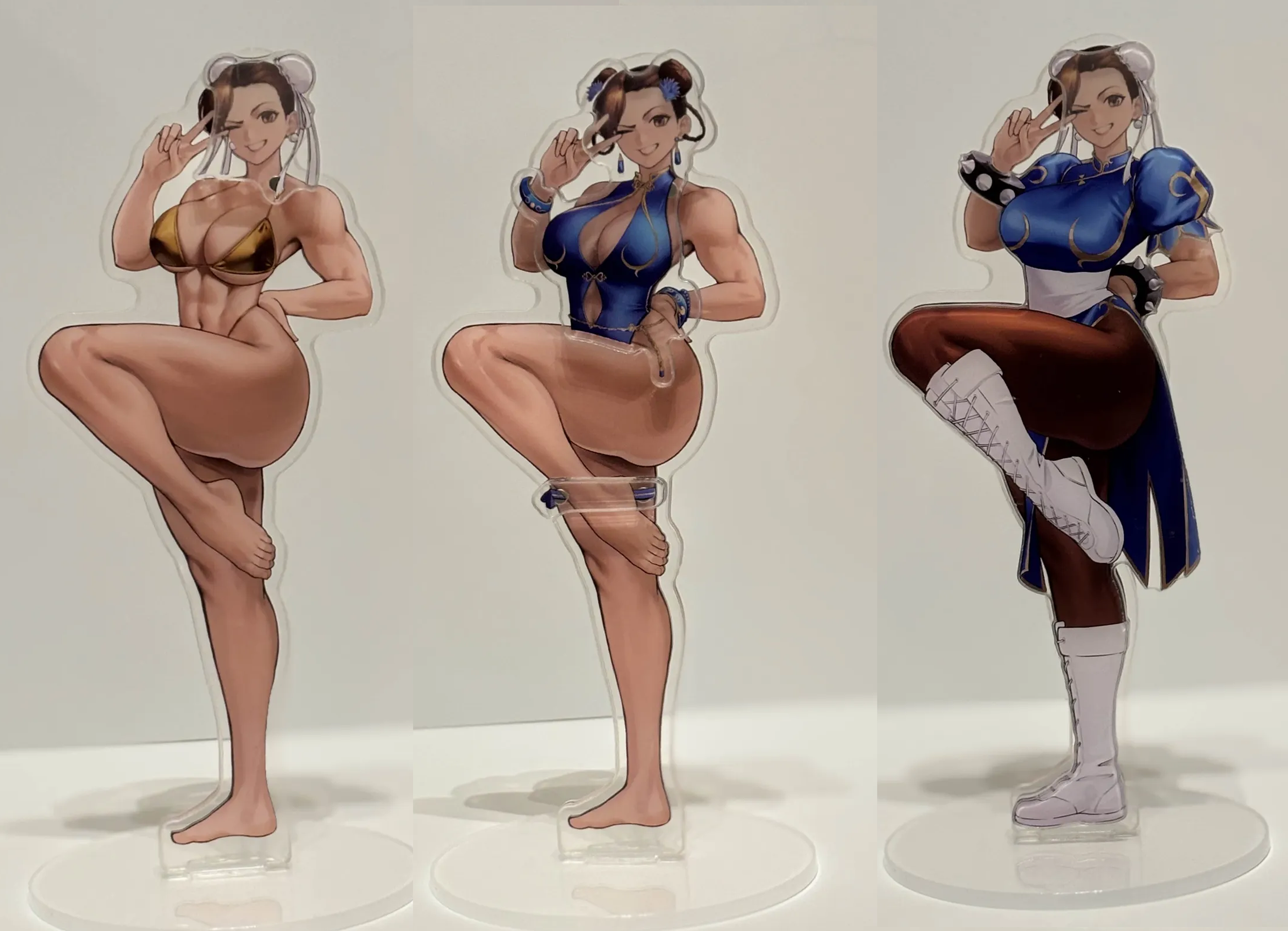 Three anime-style female character stickers with different outfits and poses, all with one leg lifted, placed on clear stands.