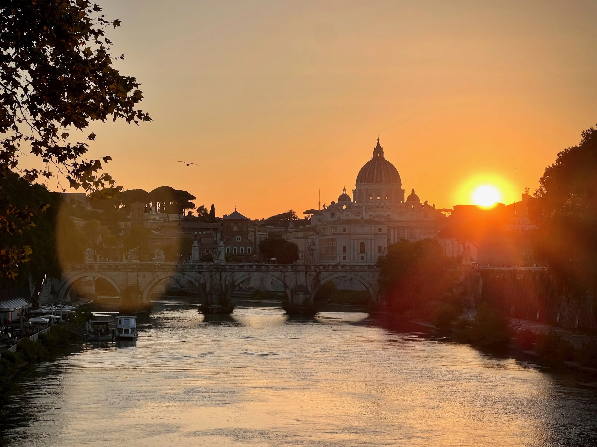 Sunset over the Tiber River with the Vatican in the distance