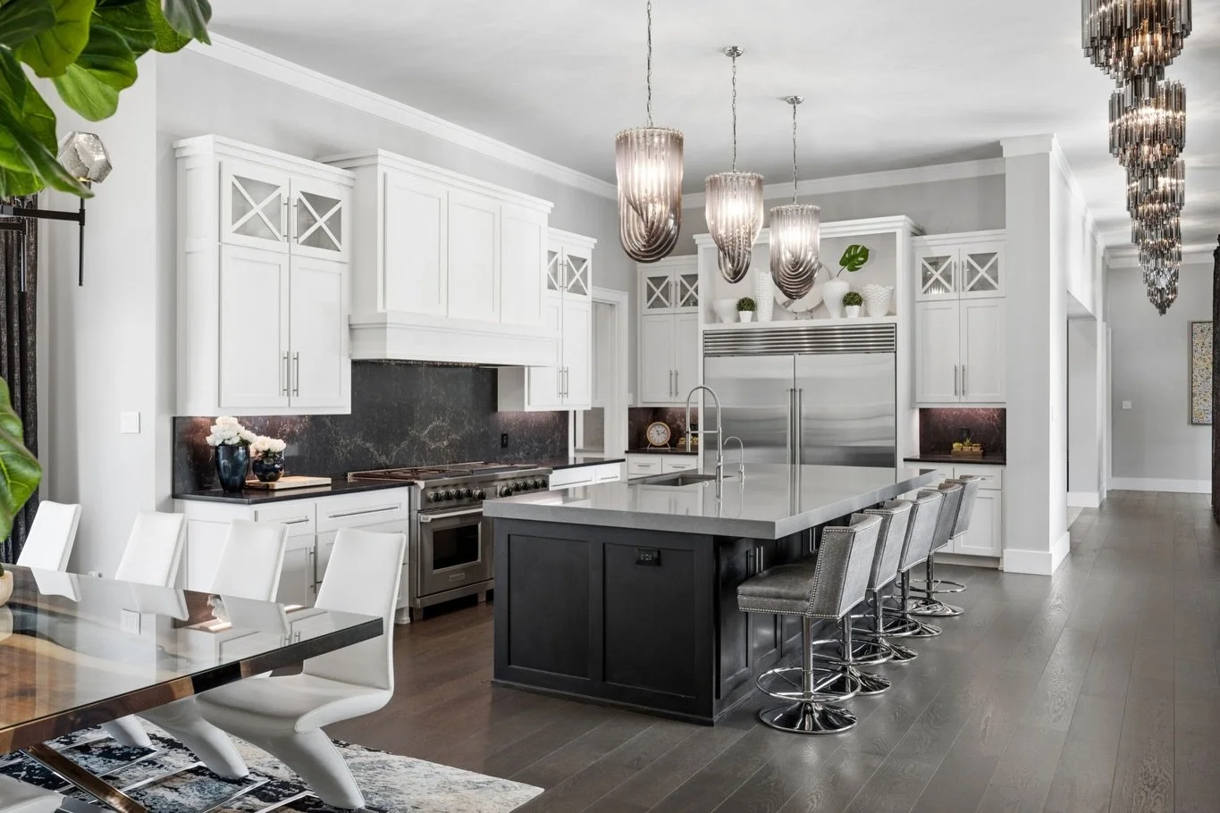 Black and white, without feeling black and white. 🖤

Bold contrast carries from the kitchen into the dining room, while layered textures, statement lighting, and thoughtful details give each space its own identity. Together, they create a seamless f