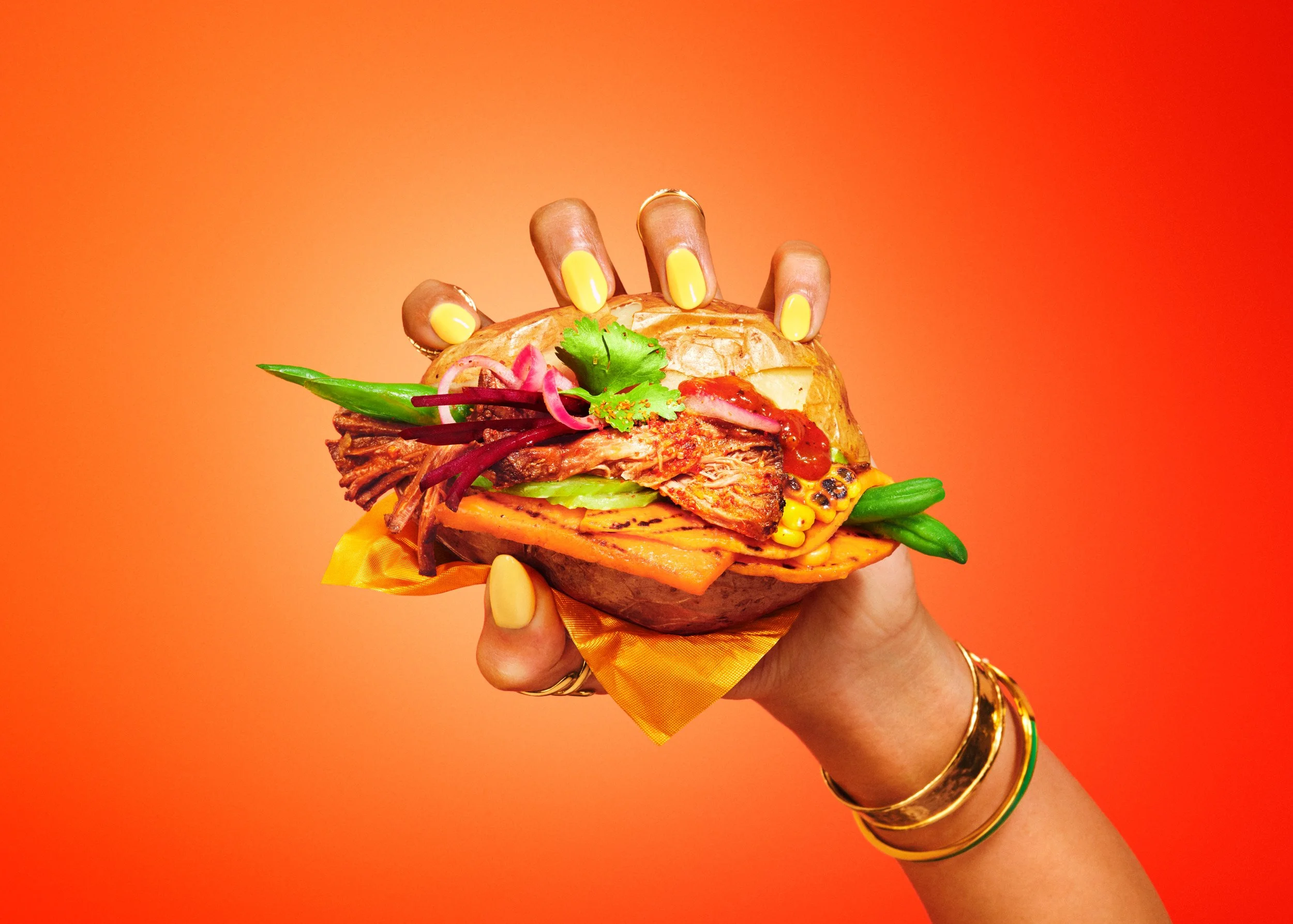 Top Sydney food Photographer Bonnie  Coumbe captured the latest Aus Veg ''Fresh veg, deliciously affordable'' latest ad campaign. Fresh vegetables in a baked potato held in a hand and shot in modern bright bold lighting. 