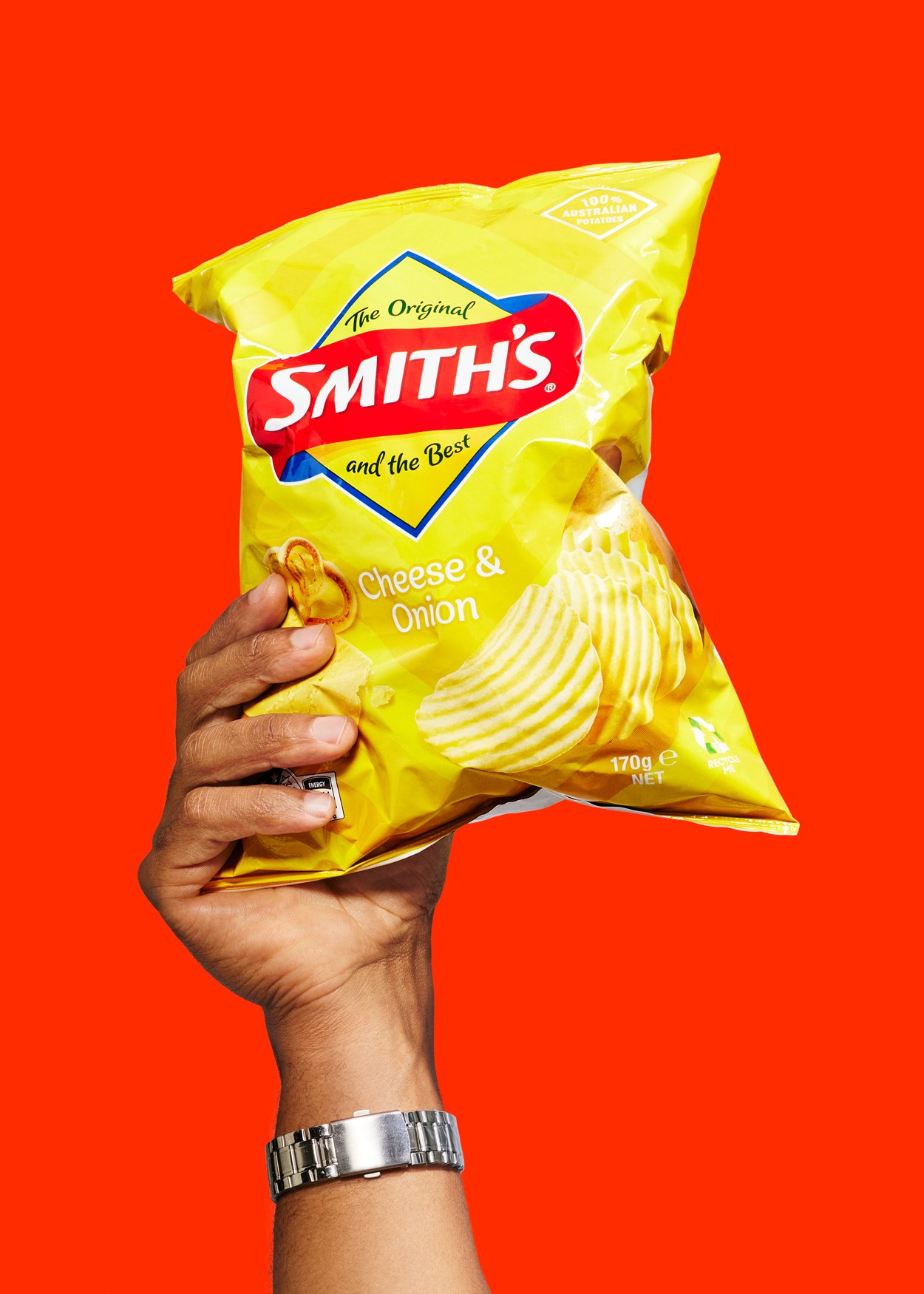 Doordash advertising campaign ''smash it''.  A hand holding a yellow bag of Smith's chips  against a red background.
