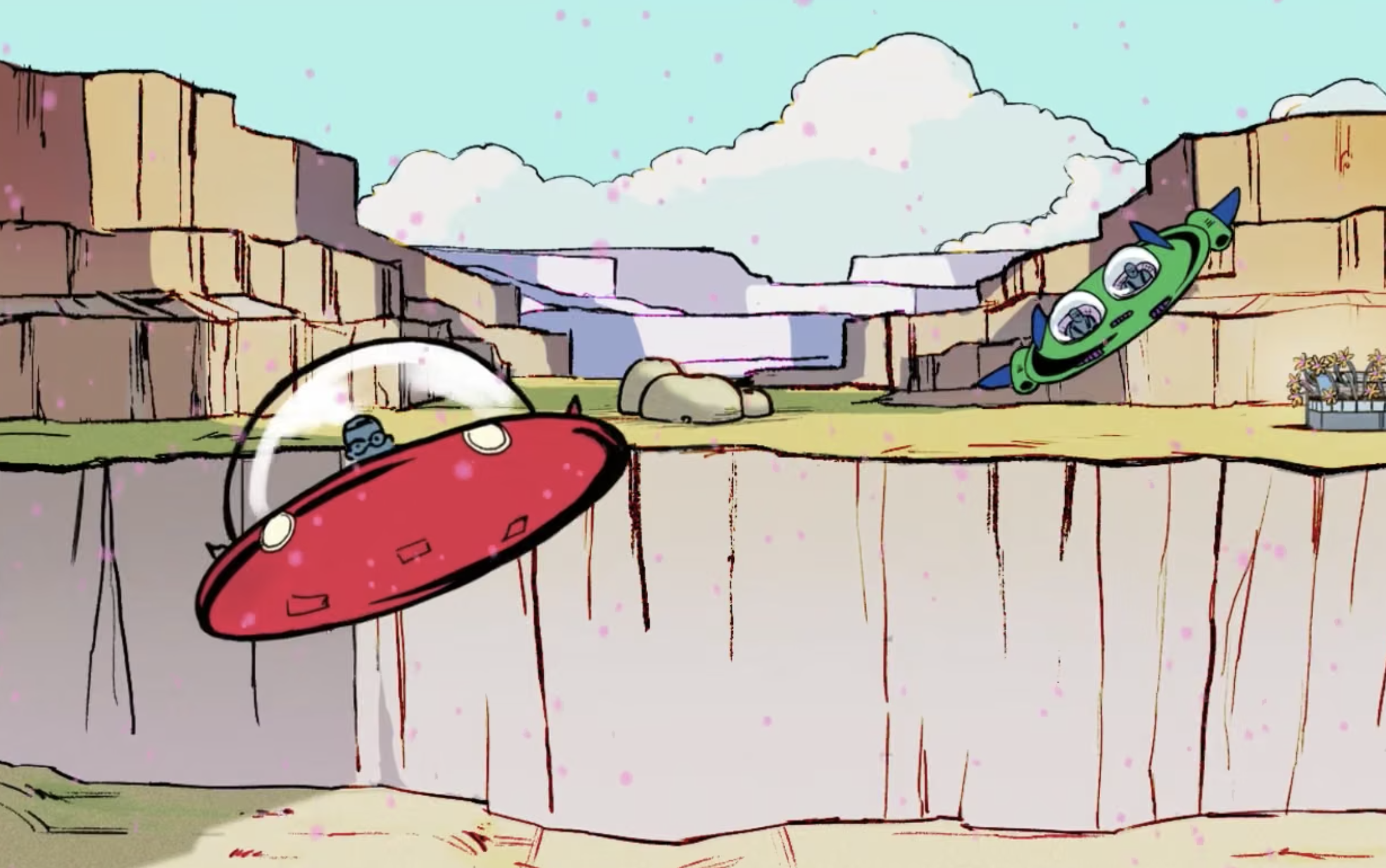 A red spaceship and a green spaceship fly over a canyon