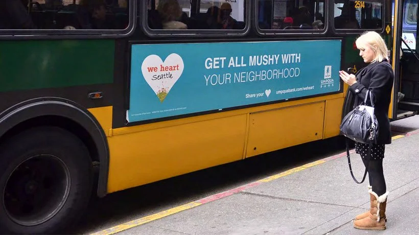 A bus board from the Umpqua Bank"We Heart" campaign that reads "Get all mushy with your neighborhood"