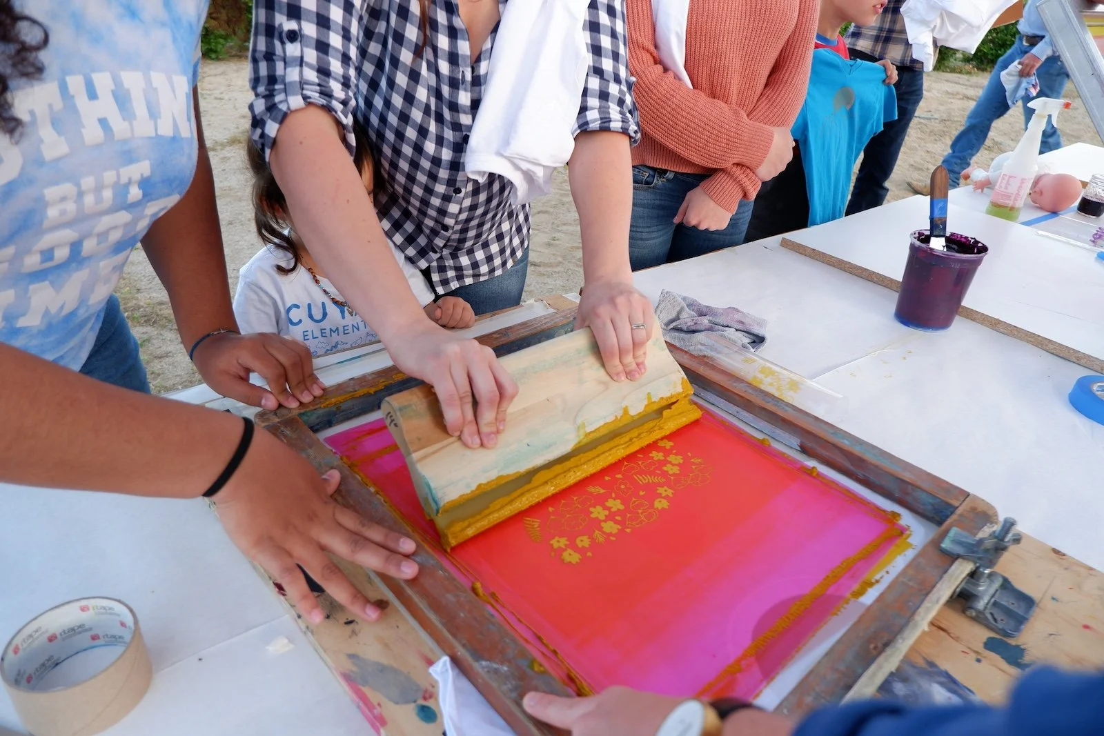 Community members screenprint bandanas at an all-ages evening event led by Desert Fellow Claudia Borfiga.