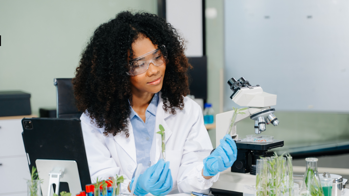 Scientist examining plant samples in a laboratory while conducting food, agricultural, or ingredient research.