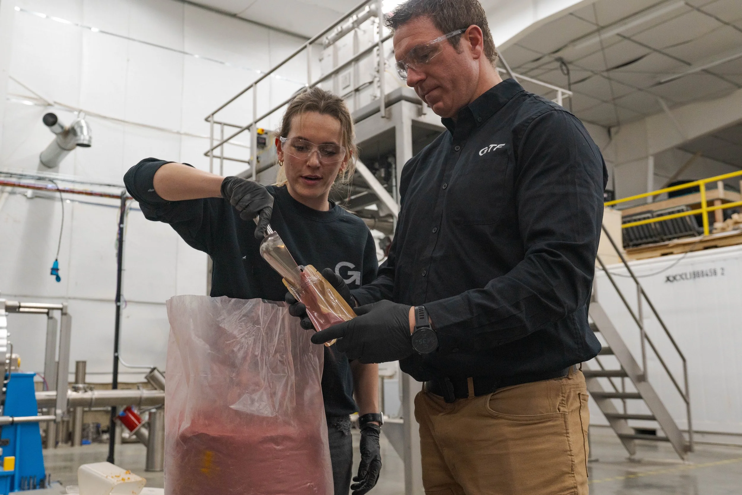 Technician conducting R&D sample run in RENU™ drying and milling system, generating powder samples for analysis